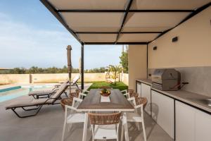a kitchen and dining room with a table and chairs at Golden Silence in Platanias