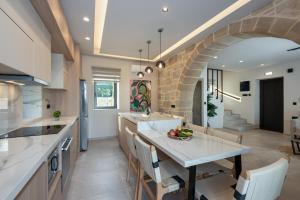 a kitchen with a table and a stone wall at Golden Silence in Platanias
