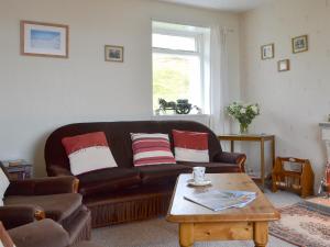 a living room with a couch and a coffee table at Tigh Mairi in Tarbert