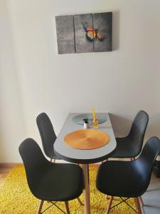 a table with chairs and a butterfly on the wall at For You in Vrnjci +2 photos