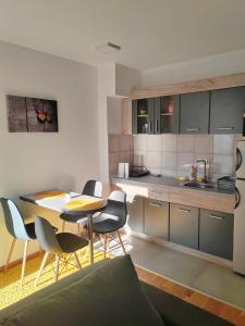 a kitchen and dining room with a table and chairs at For You in Vrnjci