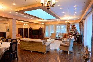 a large living room with a christmas tree in it at Sinaia ZenDen - Private Villa & SPA in Sinaia