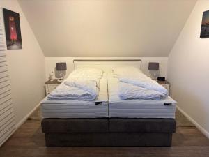 a bed in a room with two night stands at Ostseebrise-Fehmarn in Fehmarn