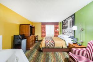 a hotel room with a bed and a tv at Super 8 by Wyndham Jacksonville in Jacksonville