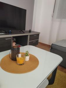 a table with a hat and a plant on it at For You in Vrnjci