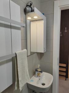 a bathroom with a white sink and a mirror at For You in Vrnjci