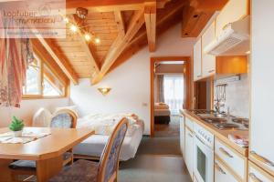 a kitchen and living room with a table and a couch at Edelweißhof in Ischgl