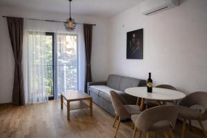a living room with a couch and a table at Bozovic Apartman 2 in Budva