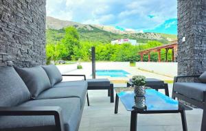 a living room with a couch and a table at Villa Lux with swimming pool in Baška
