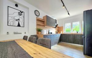 a kitchen and living room with a table and chairs at Villa Lux with swimming pool in Baška