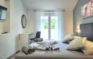 a bedroom with a large bed with a starfish on it at Villa Lux with swimming pool in Baška +27 photos