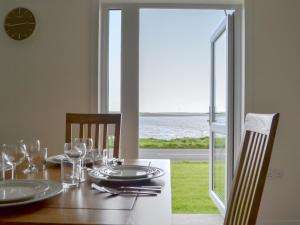 a dining room table with a view of the ocean at Rockworks Chalets No4 - Uk7043 in Saint Marys