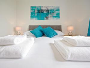 a bedroom with two white beds with blue pillows at Rockworks Chalets No4 - Uk7043 in Saint Marys