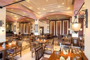a restaurant with tables and chairs in a room at Sunrise Crystal Bay Resort -Grand Select in Hurghada