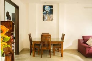 a dining room with a wooden table and chairs at Echoes of Doon in Rājpur