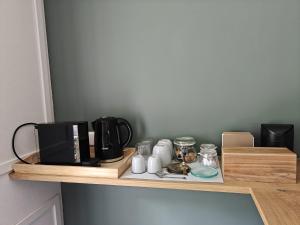 a wooden shelf with a coffee maker on it at Theehus in Steggerda