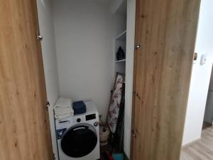 a small kitchen with a washing machine in a room at Rădăuți Residence 2 in Rădăuţi +2 photos