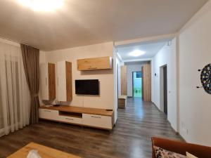 a living room with a flat screen tv on a wall at Rădăuți Residence 2 in Rădăuţi