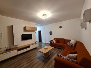 a living room with a couch and a flat screen tv at Rădăuți Residence 2 in Rădăuţi