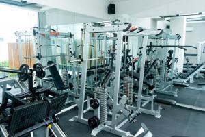 a gym with several tread machines in a room at Azana Style Hotel Tulungagung in Tulungagung