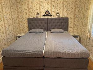 a large bed in a bedroom with wallpaper at Skillingaryds Gård in Skillingaryd