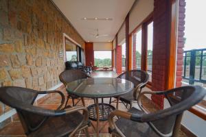 a room with a table and chairs on a balcony at Palm Cove Resort And Spa in Jāmb