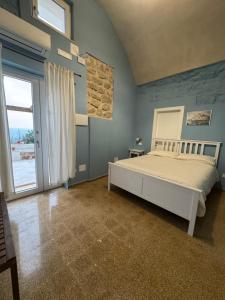 a bedroom with a bed and a large window at Il Panorama di Ercole in Monte di Procida