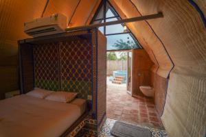a bedroom with a bed in a room with a window at Palm Cove Resort And Spa in Jāmb +114 photos