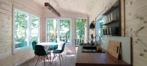 a kitchen with a table and chairs in a room at Treehouse LEA in Mikulášovice