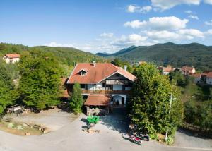 an aerial view of a house in the mountains at Butina Guesthouse in Kuterevo