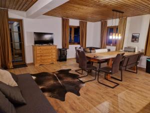 a living room with a table and chairs and a couch at Nicky apartments and studios in Niederau