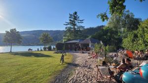 a group of people sitting in chairs on a beach at Bergflügel Fewo Allgäu, Schwimmbad, Sauna, Skilift in Missen-Wilhams