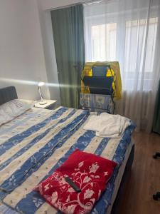 a bedroom with a bed with a blue and white comforter at Kay Borsa in Alba Iulia