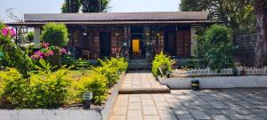 a house with a walkway in front of a garden at Elephant County Resort in Masinagudi +17 photos
