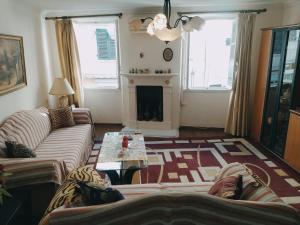 a living room with a couch and a fireplace at Spiros old town apartment in Corfu
