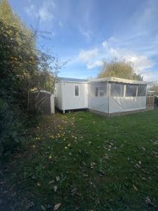 a large yard with a white house in it at mobilhome 5 personnes in Saint-Arnoult