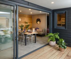 a dining room and living room with sliding glass doors at VVF Aubrac in Chaudes-Aigues