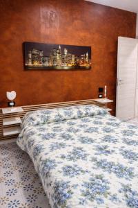 a bedroom with a large bed and a wall at Soleil Apartment - Zona Ospedale Pederzoli in Peschiera del Garda