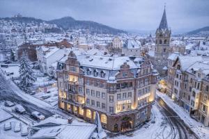 a view of a city with snow covered buildings at Hotel Kaiserhof Eisenach in Eisenach