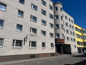 a tall brick building on a city street at Dorell in Tallinn