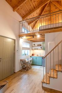 an open kitchen and dining room with a loft at Pavliani Aesthesis by Raise in Pavliani