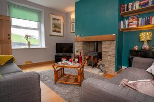 a living room with two couches and a fireplace at Fall in Green in Haworth