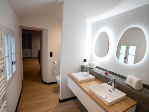 a bathroom with two sinks and two mirrors at L'unique - Love-room Romantique in Angoulême +26 photos