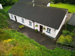 an aerial view of a white house with a black roof at Bleantis Mountain Cottage in the Comeragh Mountains in Dungarvan
