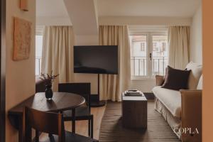 a living room with a couch and a table at Copla Bilbao in Bilbao