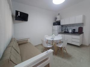 a living room with a couch and a table with chairs at San bernardo ll in San Bernardo
