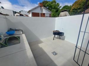 a balcony with a white wall and a table at San bernardo ll in San Bernardo