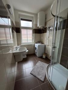 a bathroom with a sink toilet and a shower at Penzion Pollet in Pilsen