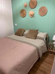 a bed in a room with hats on the wall at Piazzetta Degli Innamorati in Bari