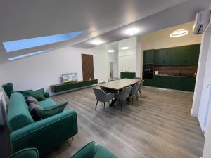 a living room with a couch and a table and chairs at Rădăuți Residence 3 in Rădăuţi